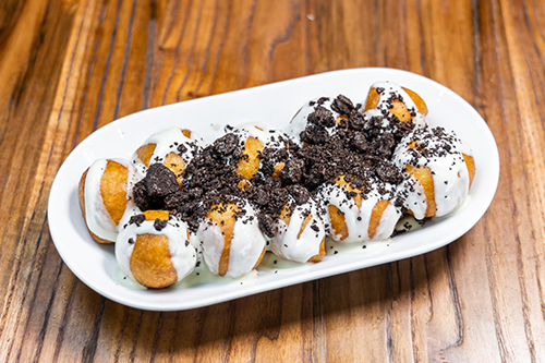Plate of Loukoumades with crushed oreo on top