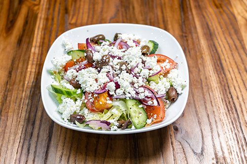 Greek salad with feta cheese, olives, tomato, onions and cucumber