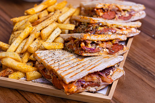 Club sandwiches' and chips on a serving board