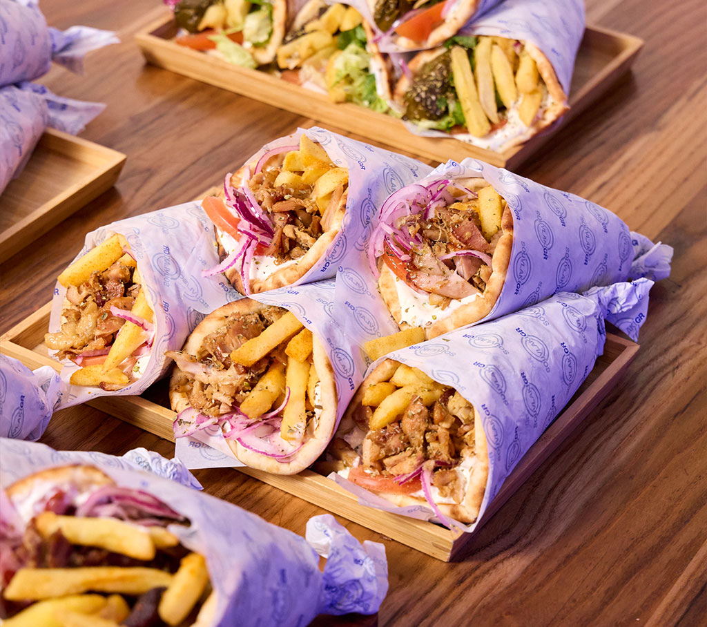 Stack of Souvlakia sitting on a wooden table
